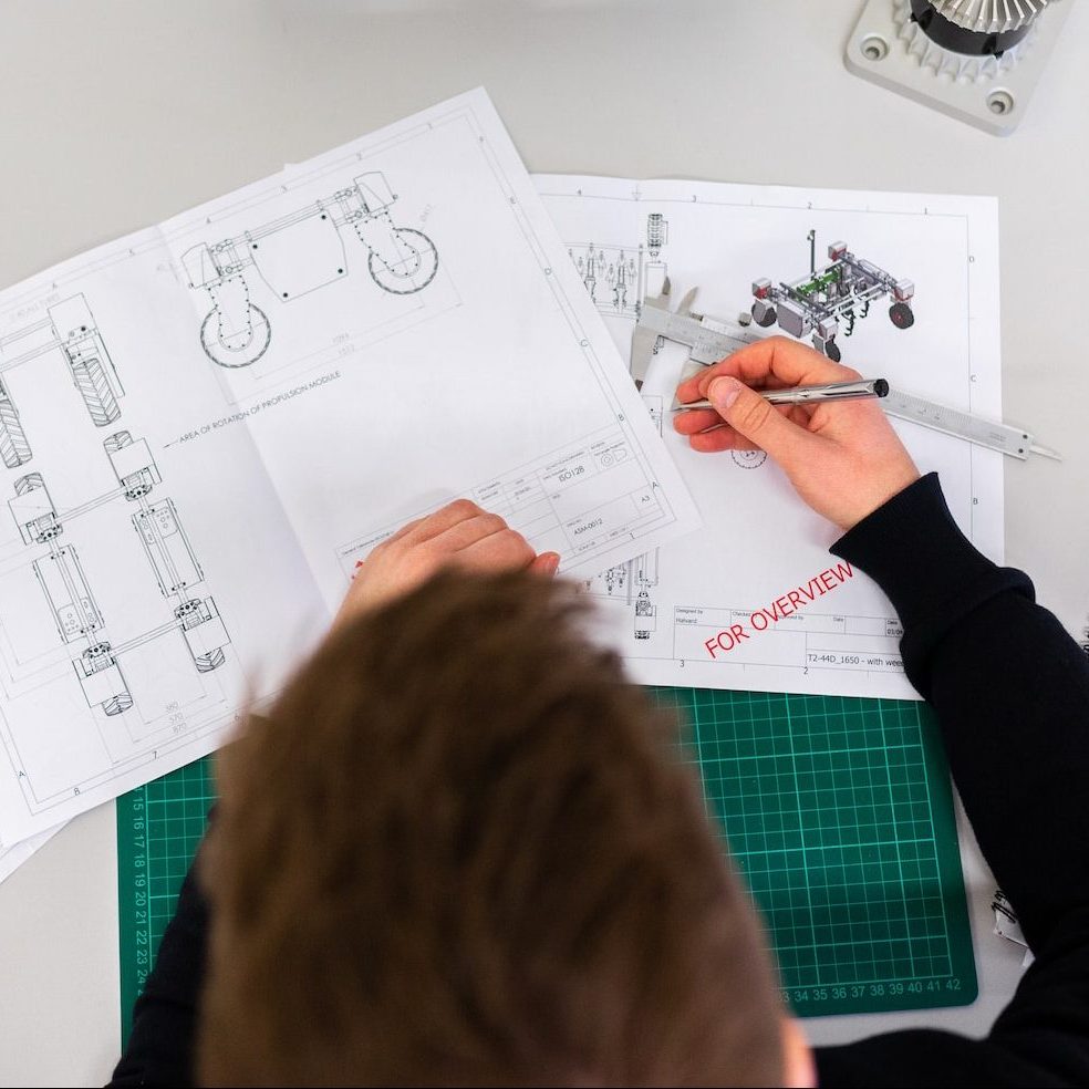 person holding white printer paper