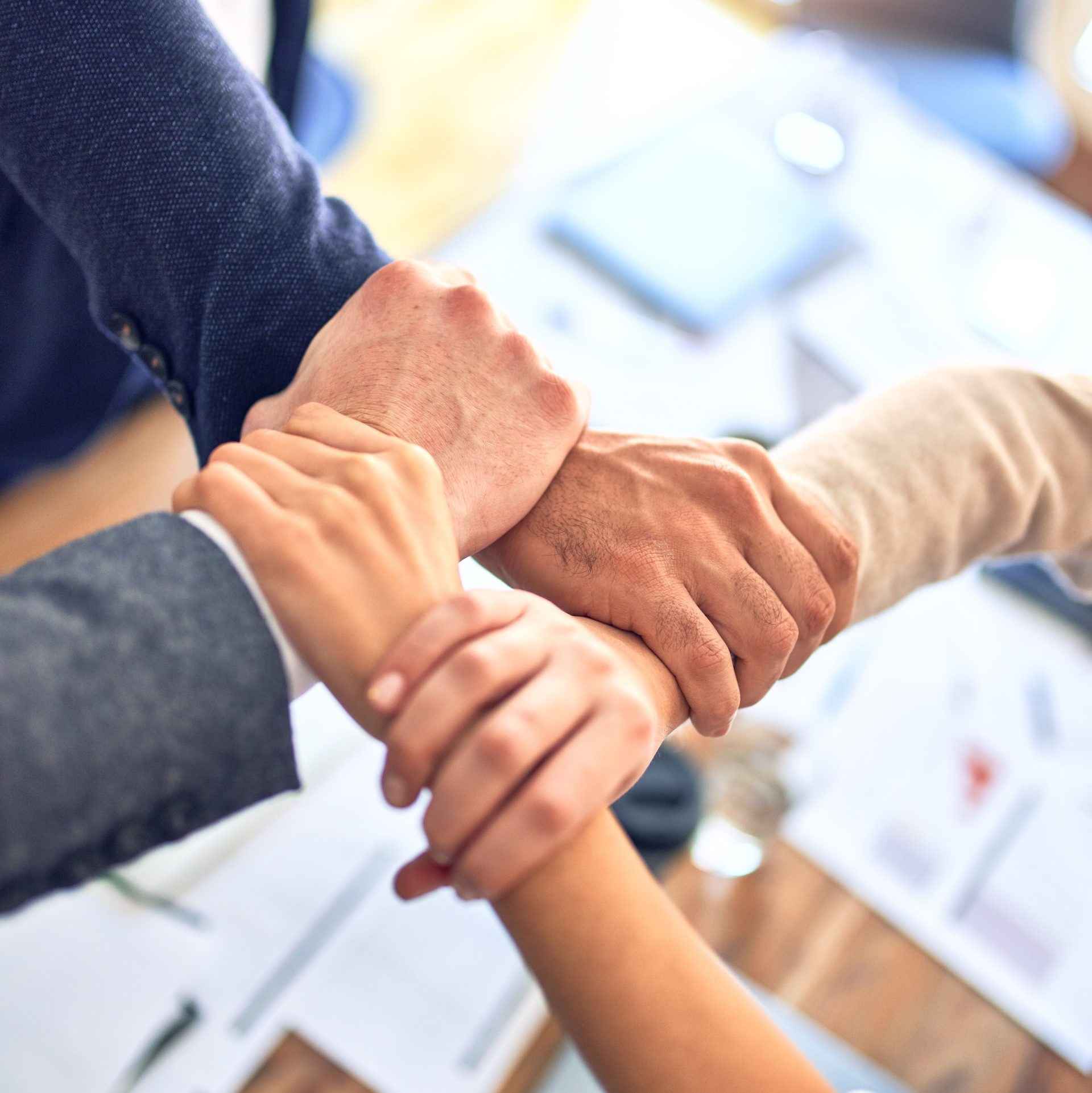 person in black long sleeve shirt holding persons hand